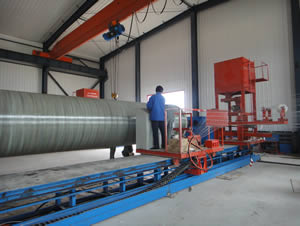 A person is working on the trolley of discontinuous filament winding machine.