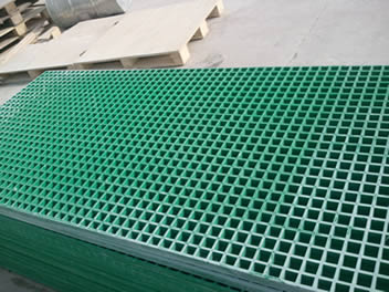 Several green FRP gratings are placed on the floor of factory.