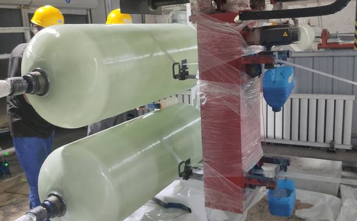 FRP composite pipe filament winding machine producing large fiberglass tubes in factory workshop